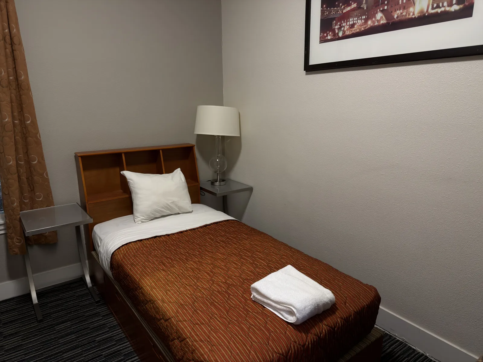 Standard room bed and bookshelf headboard