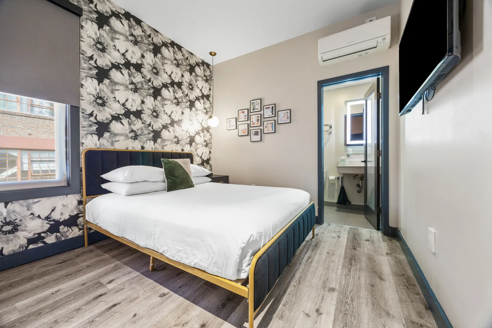 Queen room with black and white floral wallpaper